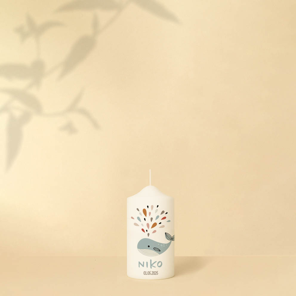 Taufkerze mit Wal, der bunte Wassertropfen spritzt, Name, Datum und Spruch personalisiert und in zwei Größen erhältlich.